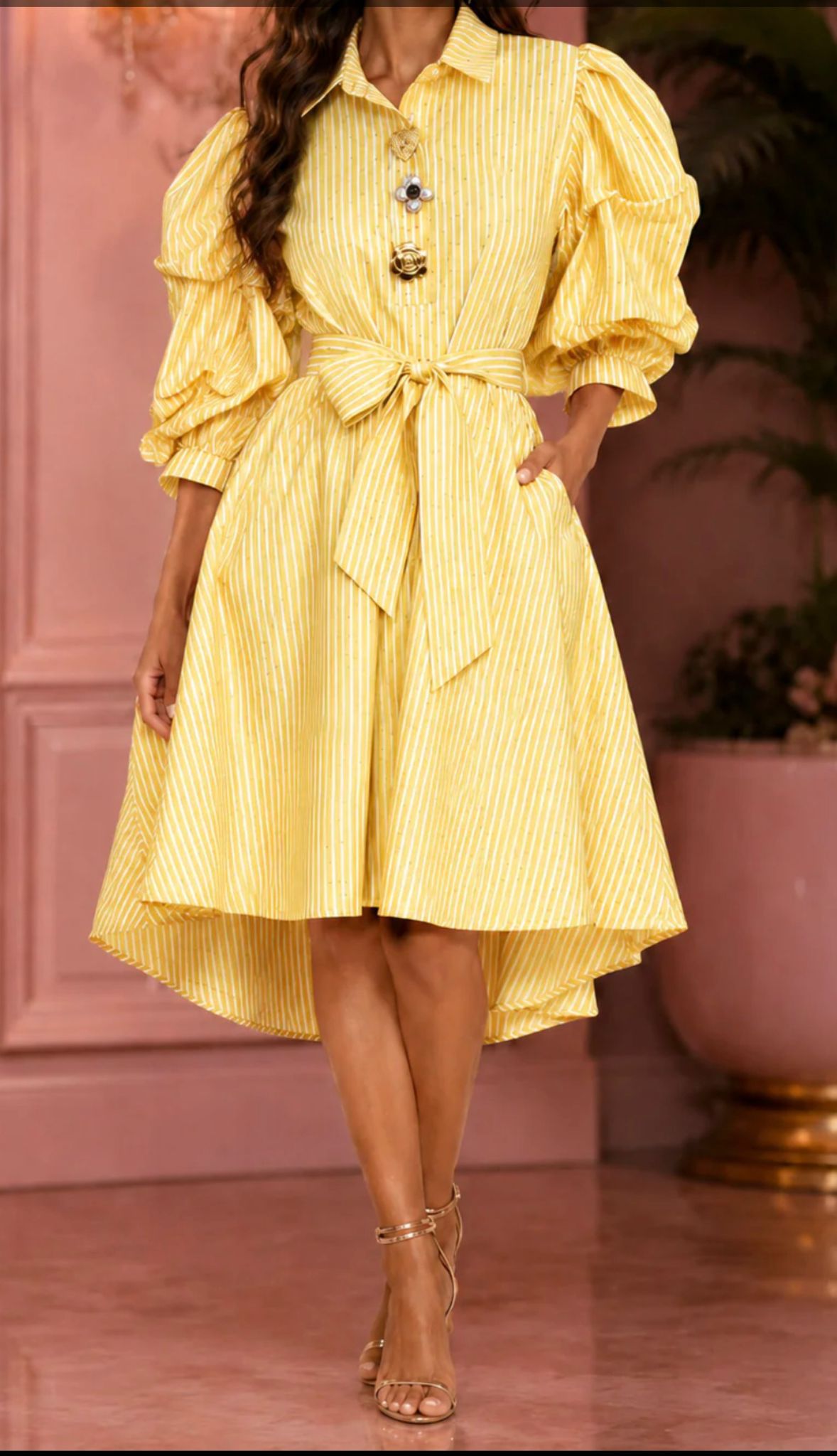 Woman wearing an elegant yellow striped high-low shirt dress