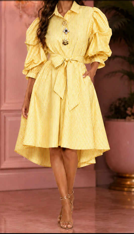 Woman wearing an elegant yellow striped high-low shirt dress